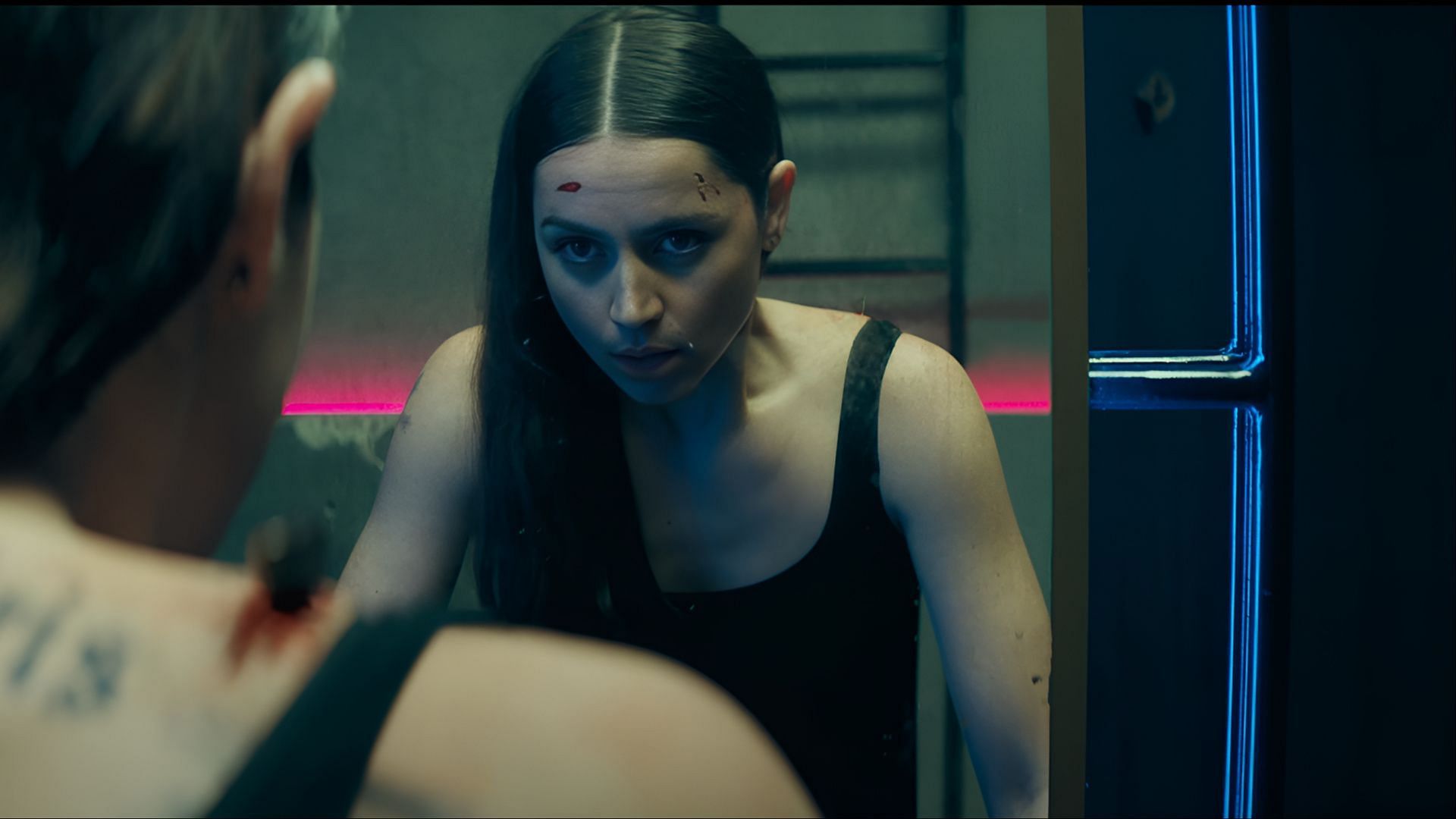 Eve faces her reflection after a brutal fight, accompanied by Fight Like A Girl from the Ballerina soundtrack, capturing her defiance. (Image via Lionsgate Movies)